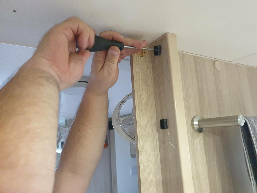 Caravan cupboards makeover on-suite bathroom concertina door. Cutting new concertina white oak look door to size