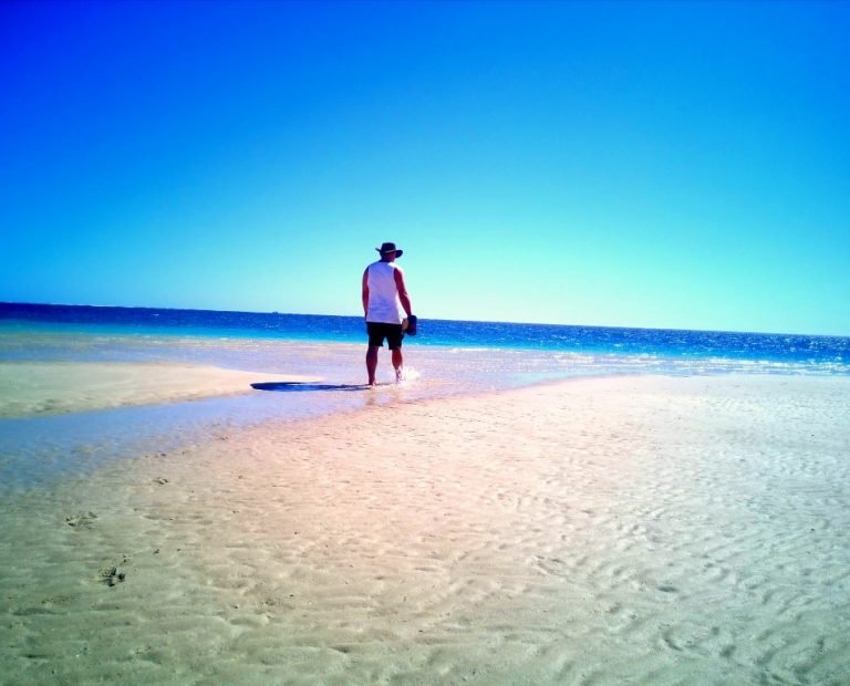 walking along Coral Bay beach