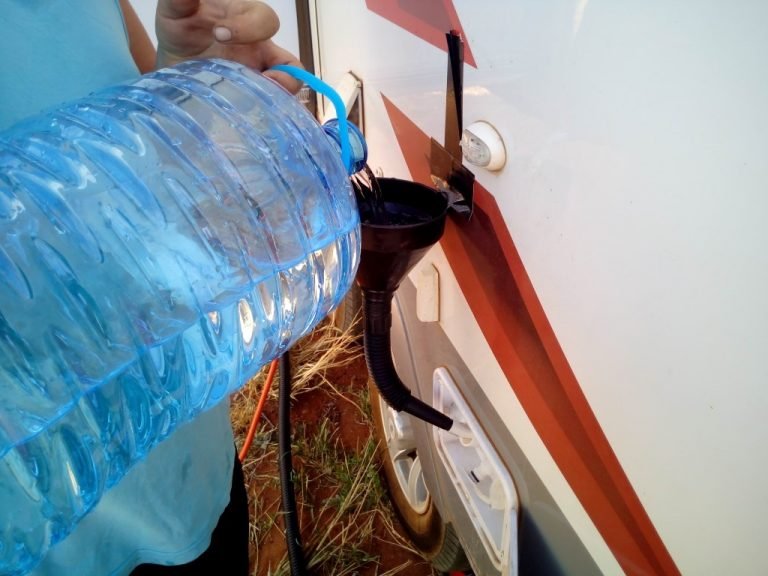 manually fill caravan water tank with funnel and water water saving tip