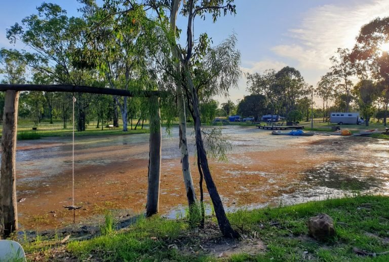 Camping Rubern Lagoon Chinchilla rope swing in to lagoon caravans in background.